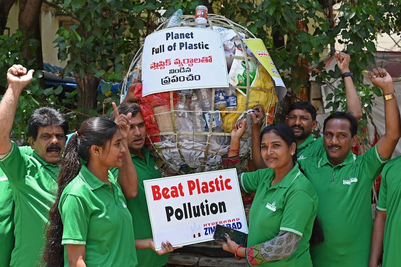 Members of the Hyderabad Zindabad Forum carry a model of the globe filled with plastic during an awareness campaign on World Environment Day in Hyderabad. AFP