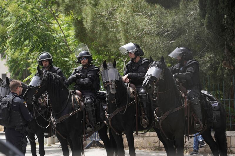 Israeli mounted police in riot gear outside the hospital where the killed veteran journalist was taken, in East Jerusalem. AP 