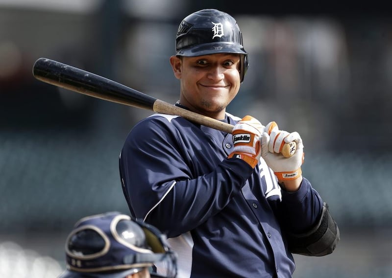 Detroit Tigers' Miguel Cabrera smiles at catcher Gerald Laird after a pitch during a workout at Comerica Park in Detroit on Monday, Oct. 22, 2012. AP Photo/Paul Sancya