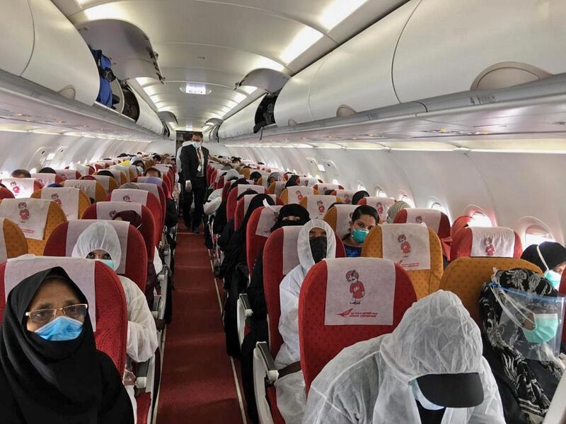 A picture provided by the Embassy of India in Riyadh shows Indian expats inside a plane upon their departure at King Fahad International Airport heading to Kozhikode. Some 150 Indian passengers, mainly consisting of pregnant women and stranded workers, left Riyadh on a special flight amid the Covid-19 pandemic. AFP / Embassy of India in Riyadh