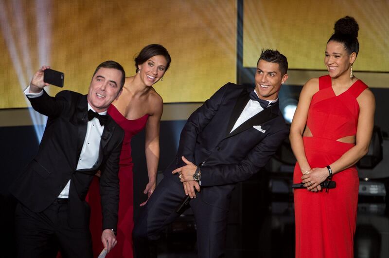 ZURICH, SWITZERLAND - JANUARY 11: Presenter James Nesbitt (L) takes a photo with (L-R) Carli Lloyd of the USA and Houston Dash, Cristiano Ronaldo of Portugal and Real Madrid and Celia Sasic of Germany during the FIFA Ballon d'Or Gala 2015 at the Kongresshaus on January 11, 2016 in Zurich, Switzerland. (Photo by Philipp Schmidli/Getty Images)