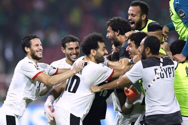 Egypt's players celebrate after winning the Africa Cup of Nations (CAN) 2021 semi-final football match between Cameroon and Egypt at Stade d'Olembe in Yaounde on February 3, 2022. (Photo by Kenzo Tribouillard / AFP)