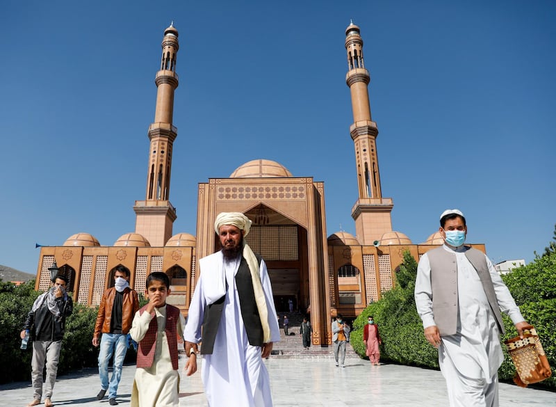 Afghans leave after prayers during Eid Al Fitr at a mosque in Kabul. REUTERS