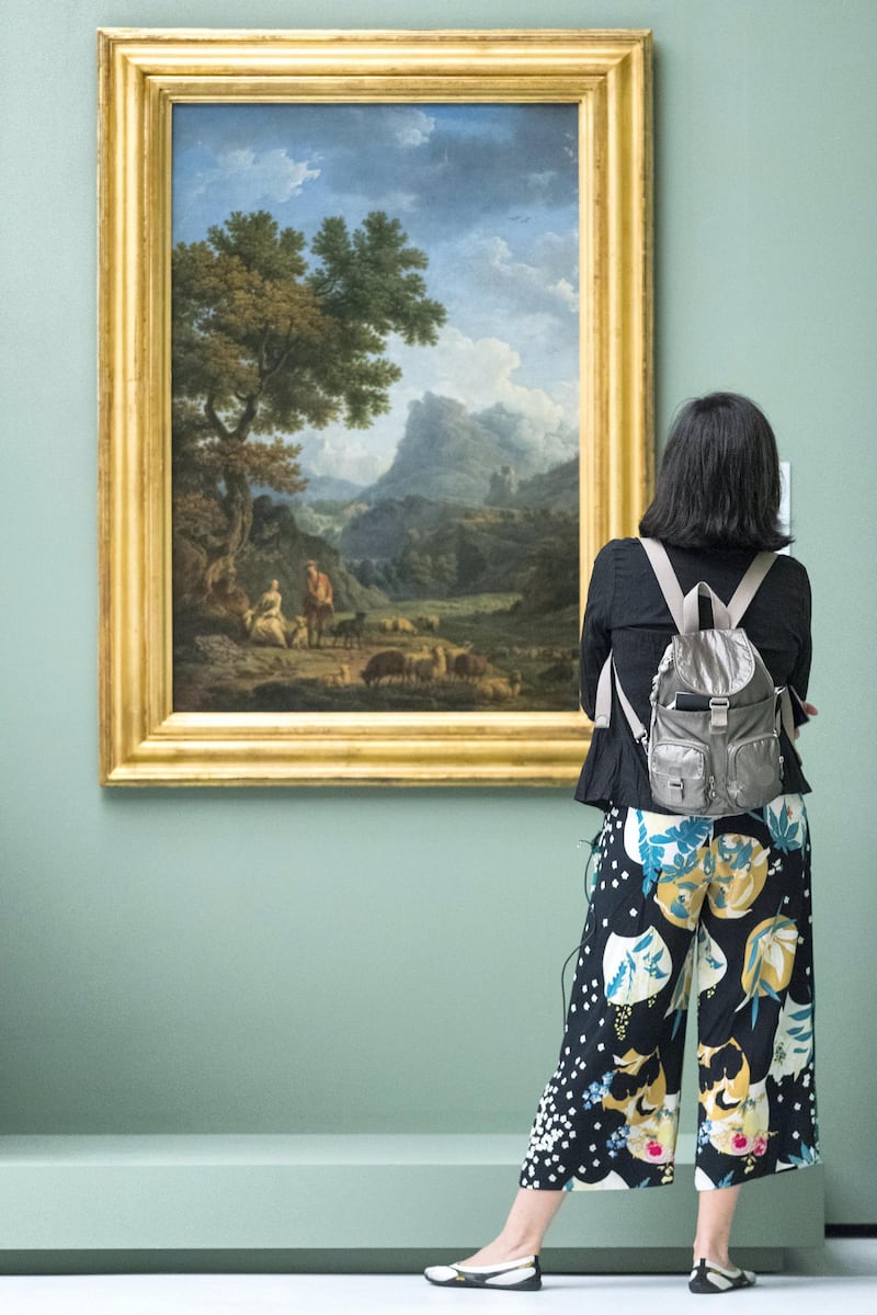 Abu Dhabi, United Arab Emirates, December 19, 2017:    
A woman looks at, The Shepherdess of the Apls by artist Joseph Vernet, seen during a media preview for the, From One Louvre to Another exhibit, at the Louvre Abu Dhabi on Saadiyat Island in Abu Dhabi on December 19, 2017. The exhibit will be open from December 21st to April 7, 2018. Christopher Pike / The National

Reporter: John Dennehy
Section: News