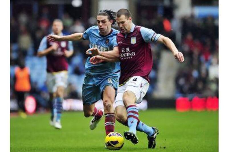 Aston Villa's Dutch defender Ron Vlaar (R) vies with West Ham United's English striker Andy Carroll (L) during the English Premier League football match between Aston Villa and West Ham United at Villa Park in Birmingham, West Midlands, England, on February 10, 2013. AFP PHOTO / GLYN KIRK

RESTRICTED TO EDITORIAL USE. No use with unauthorized audio, video, data, fixture lists, club/league logos or ìliveî services. Online in-match use limited to 45 images, no video emulation. No use in betting, games or single club/league/player publications.
 *** Local Caption *** 455428-01-08.jpg