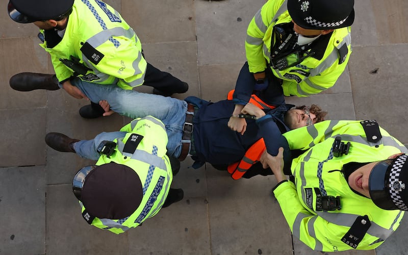 Met Police officers remove a Just Stop Oil climate activist. AFP