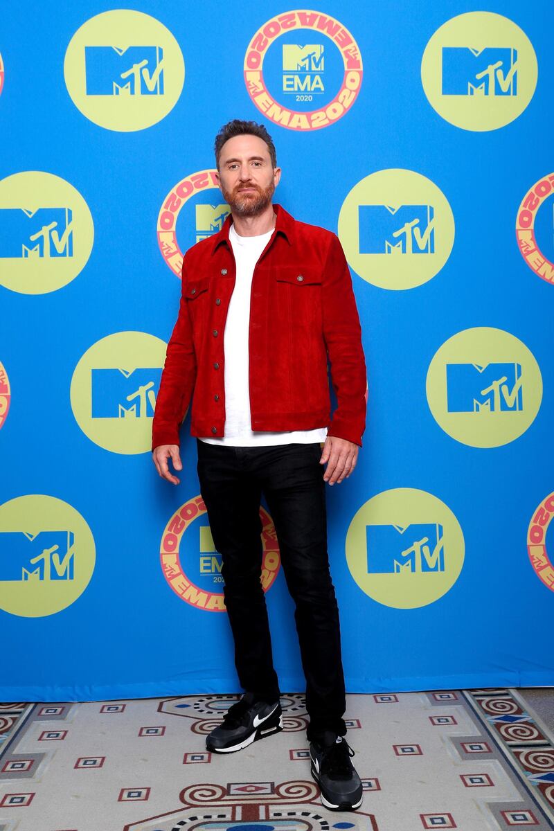 David Guetta, in a red jacket, poses ahead of the MTV EMAs in Budapest, Hungary. Reuters