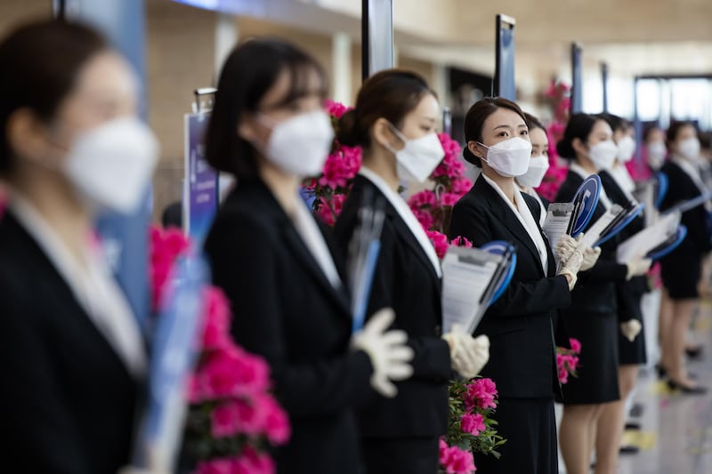 Event staff wear protective masks during the Samsung Electronics Co. annual general meeting at the Suwon Convention Centre in Suwon, South Korea. Bloomberg