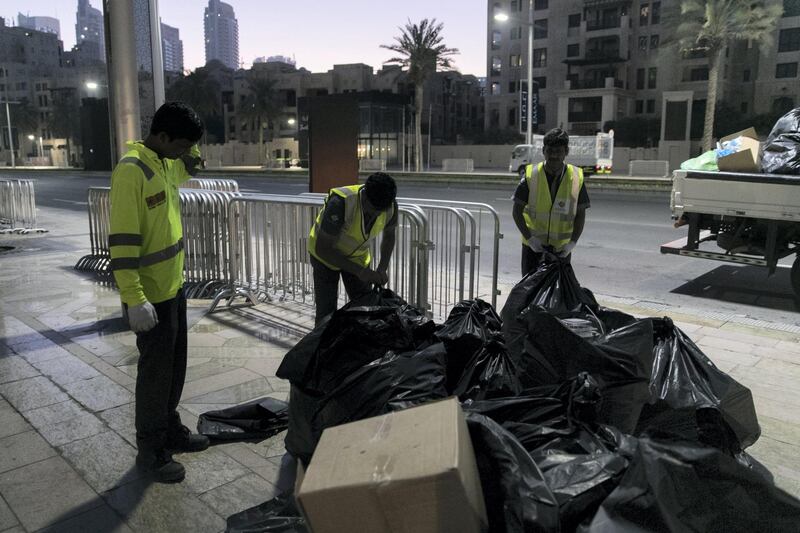 DUBAI, UNITED ARAB EMIRATES - Jan 1, 2018. 

On their seventh clean up rotation for the night, sweepers clean the streets at Downtown Dubai after New Year's Eve.

(Photo by Reem Mohammed/The National)

Reporter: Nawal Al Rawahi

Section: NA