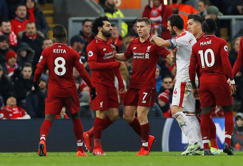 Liverpool's James Milner attempts to seperate Mohamed Salah from Crystal Palace's Luka Milivojevic as they clash after Salah went to ground easily. Reuters