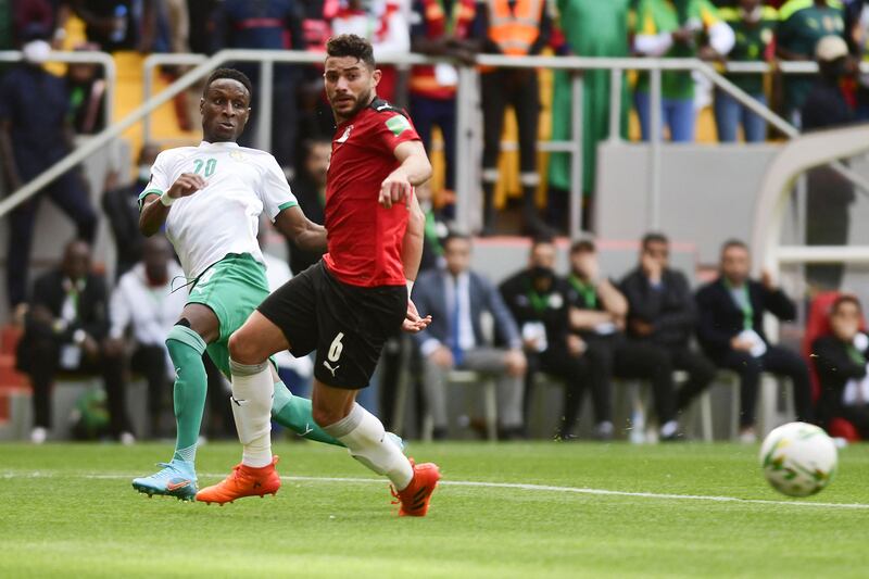 Senegal's Bouna Sarr passes the ball under pressure from Yasser Ibrahim of Egypt. AFP