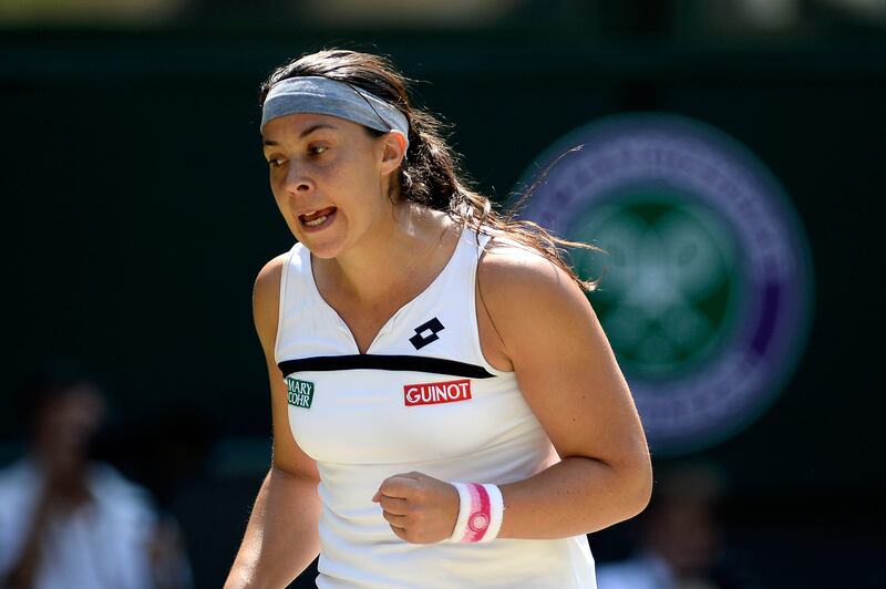 LONDON, ENGLAND - JULY 06:  Marion Bartoli of France celebrates a point during the Ladies' Singles final match against Sabine Lisicki of Germany on day twelve of the Wimbledon Lawn Tennis Championships at the All England Lawn Tennis and Croquet Club on July 6, 2013 in London, England.  (Photo by Dennis Grombkowski/Getty Images) *** Local Caption ***  173067111.jpg