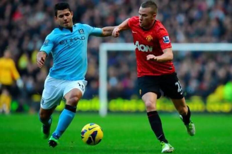 Manchester City's Sergio Aguero, left, and Manchester United's Tom Cleverley.