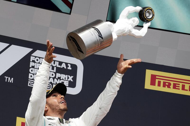 epa07668404 British Formula One driver Lewis Hamilton of Mercedes AMG GP celebrates with his trophy on the podium after winning the 2019 French Formula One Grand Prix at Paul Ricard circuit in Le Castellet, France, 23 June 2019.  EPA/YOAN VALAT