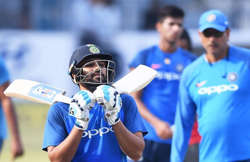 India's captain Rohit Sharma gestures as he walks out after batting in the nets during a training session ahead of the first Twenty20 International cricket match between India and Sri Lanka at the Barabati Stadium in Cuttack on December 19, 2017. / AFP PHOTO / Dibyangshu SARKAR