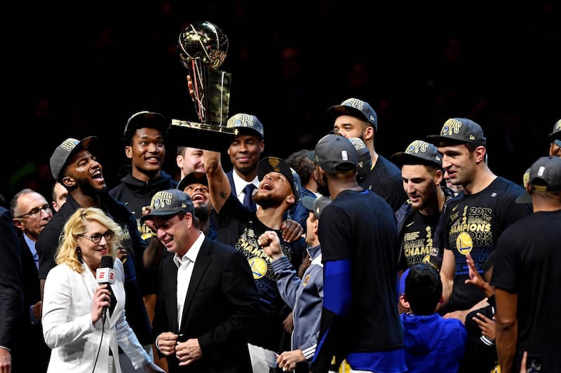 Golden State Warriors guard Stephen Curry celebrates with the Larry O'Brien Championship Trophy after beating the Cleveland Cavaliers in game four. Ken Blaze / Reuters