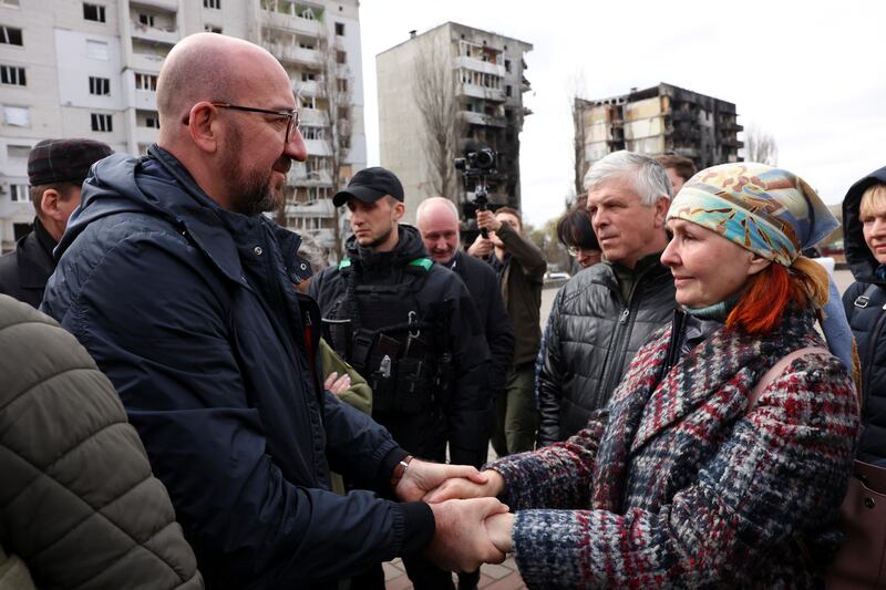 European Council President Charles Michel greets a woman in Borodianka during a visit on April 20. Reuters