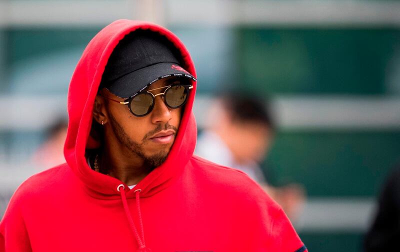 Mercedes' British driver Lewis Hamilton walks down the paddock prior to the Formula One Chinese Grand Prix in Shanghai on April 12, 2018.  / AFP PHOTO / Johannes EISELE