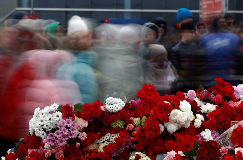 People gather at a makeshift memorial to the victims of the Crocus City Hall shooting attack in the Moscow region on Sunday. Reuters