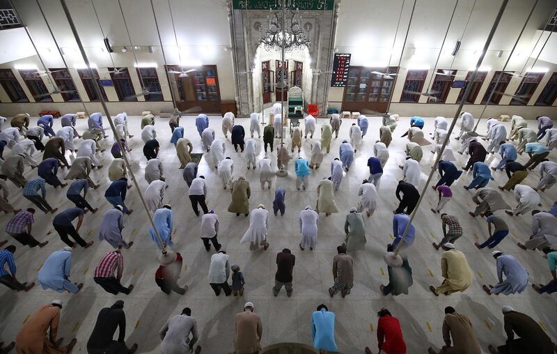 epa08372048 Muslim men pray at a mosque while maintaining social distancing during a lockdown of Sindh province, in Karachi, Pakistan, 19 April 2020. Pakistani authorities have already extended lockdown measures to prevent the spread of CSARS-CoV-2 coronavirus which causes the COVID-19 disease by two weeks to 18 April, but announced that it would allow the reopening of some industries and construction in order to prevent an economic collapse  EPA/SHAHZAIB AKBER