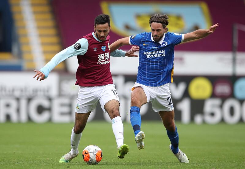 BURNLEY, ENGLAND - JULY 26: Dwight McNeil of Burnley and Davy Propper of Brighton and Hove Albion battle for the ball during the Premier League match between Burnley FC and Brighton & Hove Albion at Turf Moor on July 26, 2020 in Burnley, England. Football Stadiums around Europe remain empty due to the Coronavirus Pandemic as Government social distancing laws prohibit fans inside venues resulting in all fixtures being played behind closed doors. (Photo by Nick Potts/Pool via Getty Images)