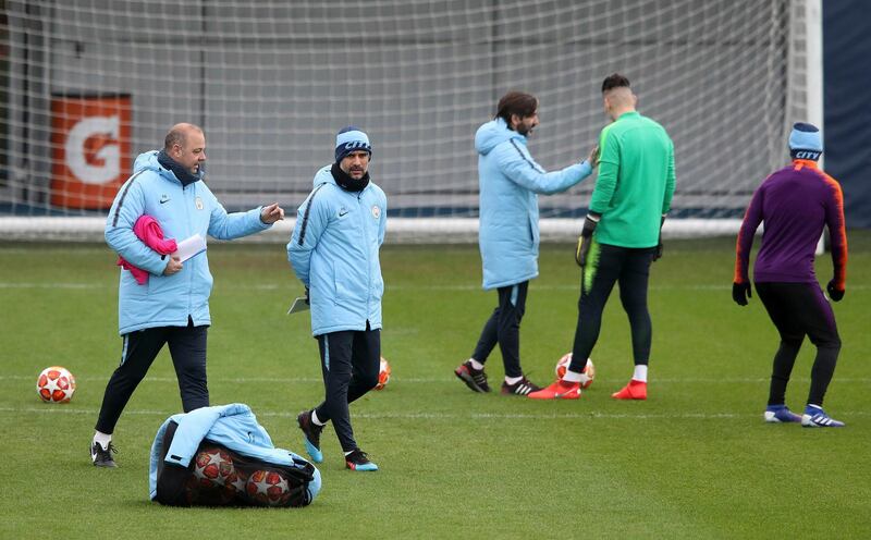 Manchester City manager Pep Guardiola, 2nd left, with assistant Rodolfo Borrell, left, during a team training session at the City Football Academy in Manchester, England, Tuesday Feb. 19, 2019. Man City will play Schalke in the champions League round of 16 first leg match on upcoming Wednesday. (Nick Potts/PA via AP)