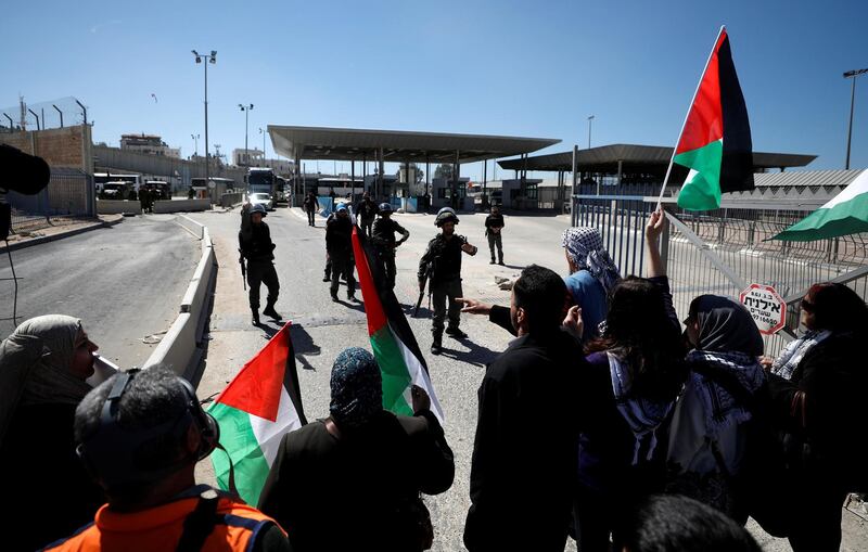 Palestinian women in the West Bank stand in front of Israeli troops during a protest against US president Donald Trump's decision to move its embassy to Jerusalem. Mohamad Torokman / Reuters