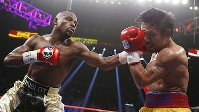 Floyd Mayweather Jr, left, lands a left to the head of Manny Pacquiao, during their welterweight title fight on Saturday, May 2, 2015 in Las Vegas. AP Photo