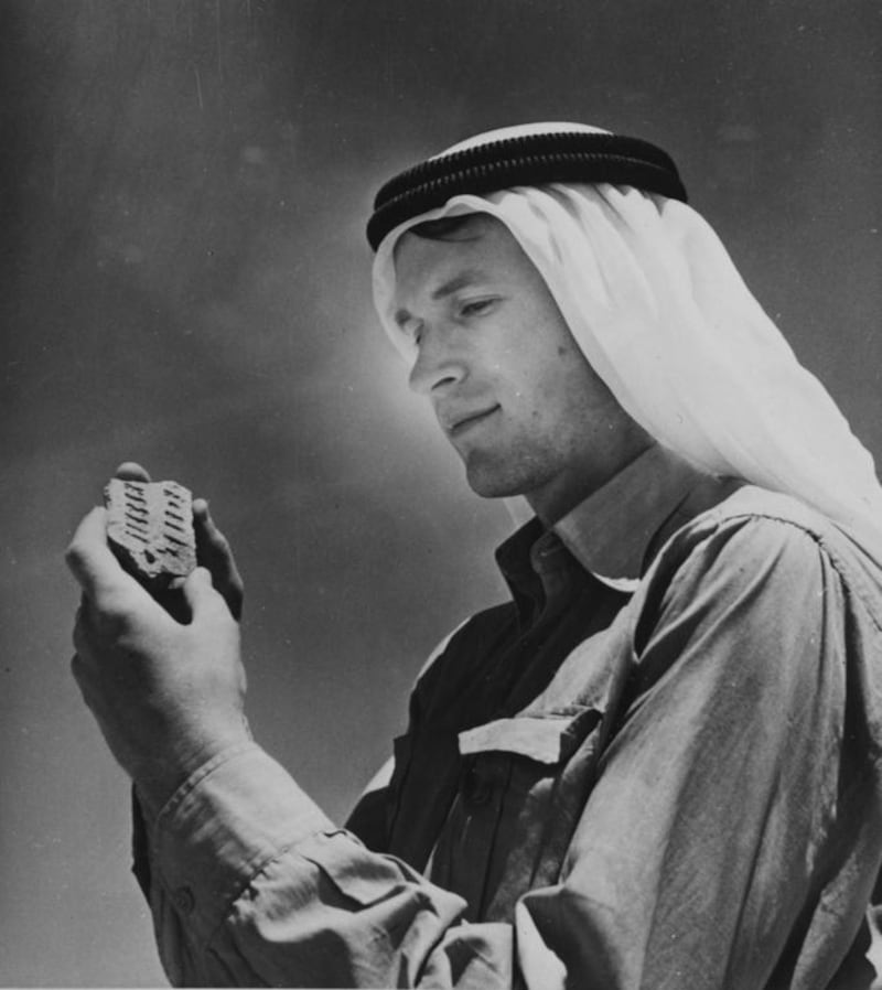 Wendell Phillips discovering an ancient identification 'dog tag' of a Qataban resident. Courtesy American Foundation for the Study of Man.