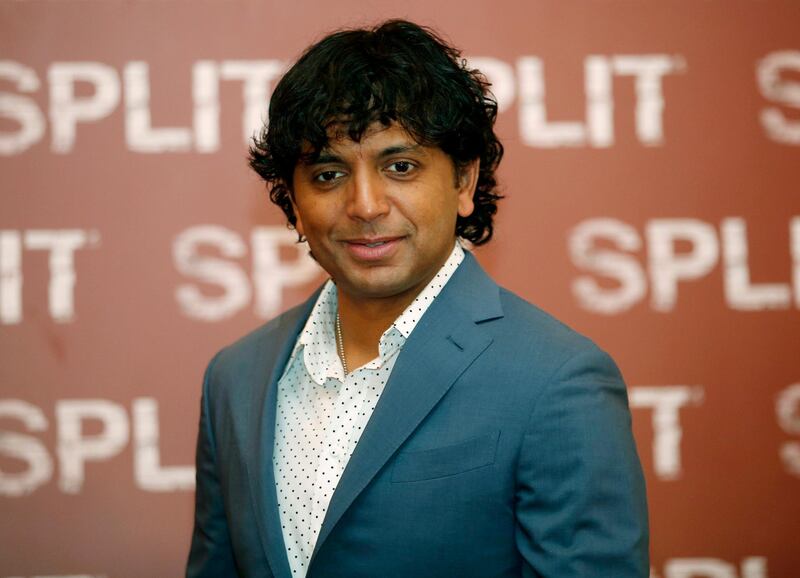 FILE- In this Jan. 11, 2017 file photo, director M. Night Shyamalan poses during a photo call for the movie "Split" in Milan, Italy, Shyamalan says he could have launched the trailer for â€œGlassâ€ in front of the summerâ€™s biggest movies in theaters, but that he wanted to hold it for Comic-Con. The filmmaker said Friday, July 20, 2018, at the annual comic book convention that he felt strongly that the Hall H audience should be the first to see it. (AP Photo/Antonio Calanni, File)