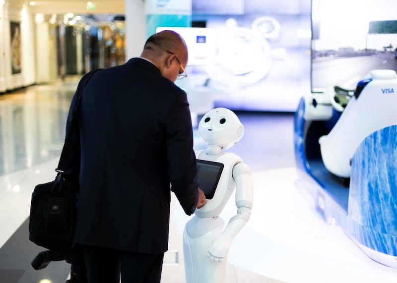 DUBAI, UNITED ARAB EMIRATES. 3 NOVEMBER 2019. 
A man interacts with Pepper at Emirates NBD branch in Emirates Towers.
Dubai Future Foundation (DFF) launched Dubai Future Week which offers a schedule of community events and interactive workshops at AREA 2071 in Emirates Tower, as part of efforts to offer a global futuristic experience that promotes technological knowledge and applications.

Under the theme: “Imagining, Designing and Executing the Future”, participants will have the opportunity to preview international films that envision the future, play Human Experience 2.0, an awareness game that introduces futuristic technologies, marvel at the Future Exhibition of images, shopping and the future of food, and engage in Future Dialogues which will explore various sectors such as education, workforce, economics and transportation.

(Photo: Reem Mohammed/The National)

Reporter:
Section: