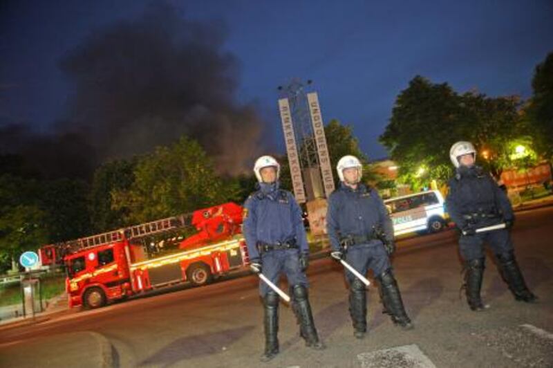 Police cordon off the area after riots in the Stockholm suburb of Rinkeby early June 9, 2010.  Up to 100 youths rioted for two straight nights in a heavily immigrant suburb of Stockholm, throwing bricks, setting fires and attacking the local police station, police said today. AFP PHOTO / FREDRIK PERSSON