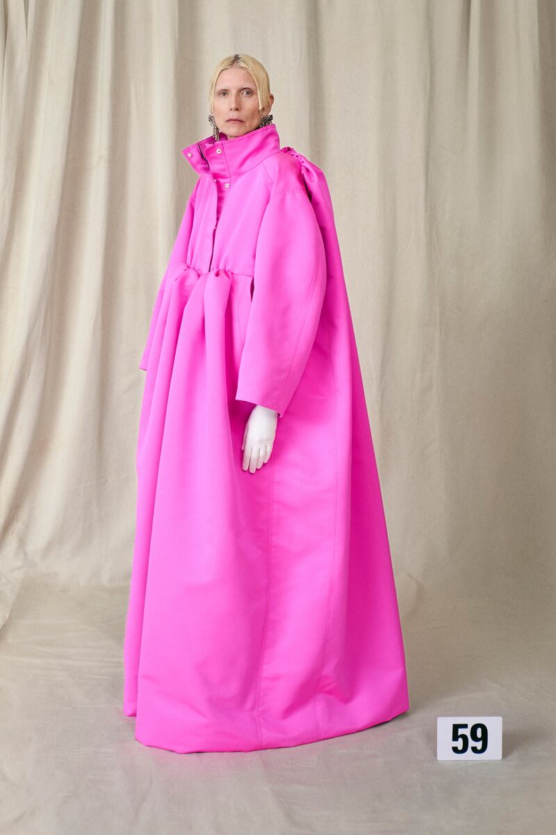 Balenciaga's famous baby doll dress was updated as a satin funnel-necked parka in shocking pink.