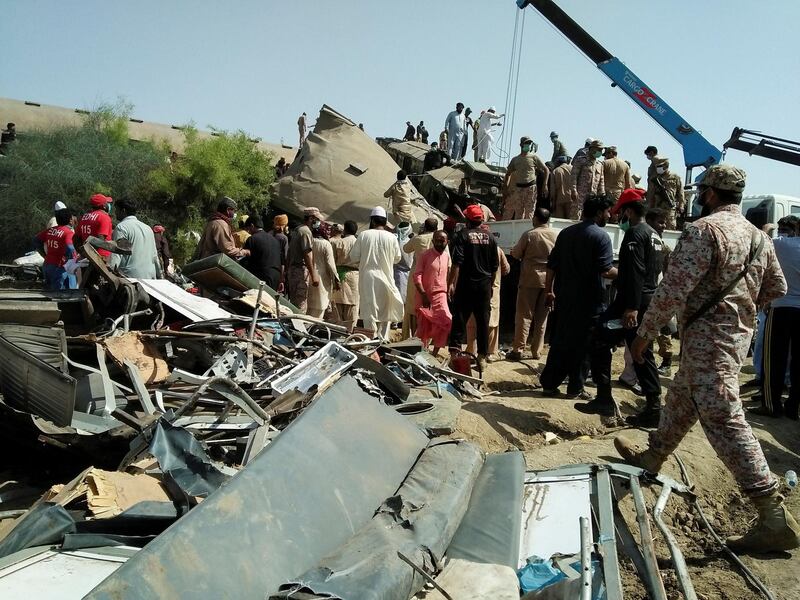Paramilitaries and rescue workers gather at the site of a train crash in Ghotki, southern Pakistan. Reuters