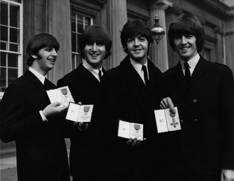 British rock group the Beatles after each received an MBE at Buckingham Palace in London, 26th October 1965. From left to right, Ringo Starr, John Lennon, Paul McCartney, George Harrison. (Photo by William Vanderson/Fox Photos/Hulton Archive/Getty Images)