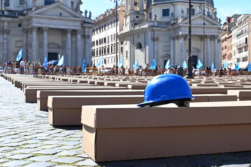 Cardboard coffins are set up at Piazza del Popolo by the Italian Labour Union during a campaign to draw public attention to work-related deaths, in Rome. EPA