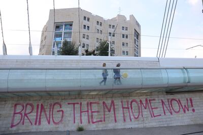 A plea to the Israeli government spray-painted on the route taken by family members, friends and supporters of hostages in their march from Tel Aviv to Jerusalem. EPA