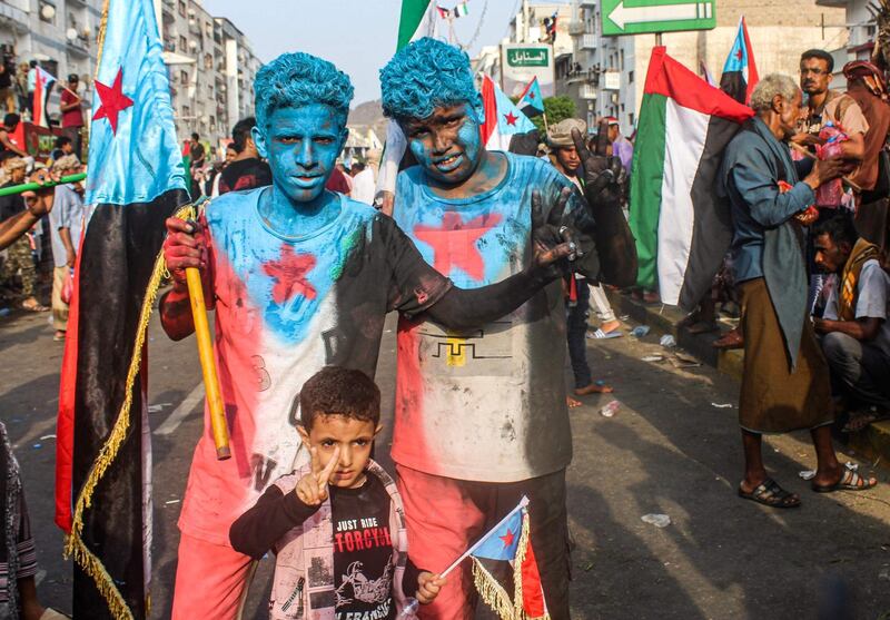 Youths wearing body-paint in the colours of the flag of South Yemen flash the victory sign during a demonstration titled the "million-man march of gratitude for Saudi Arabia and the UAE" in the centre of the second city of Aden.  AFP