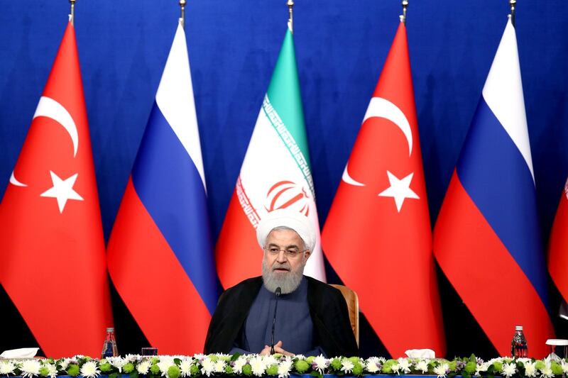 Iran's President Hassan Rouhani speaks in a joint press conference with Russia's President Vladimir Putin and Turkey's President Recep Tayyip Erdogan in Tehran, Iran, Friday, Sept. 7, 2018. Putin, Erdogan and Iran's President Hassan Rouhani began a meeting Friday in Tehran to discuss the war in Syria, with all eyes on a possible military offensive to retake the last rebel-held bastion of Idlib. (AP Photo/Ebrahim Noroozi)
