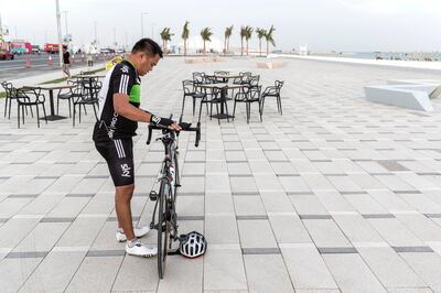 ABU DHABI, UNITED ARAB EMIRATES. 27 MAY 2018. Opening of Hudayriat beach next to Al Bateen beach.
A man takes a break from cycling on the cycle track. (Photo: Antonie Robertson/The National) Journalist: Haneen Dajani. Section: National.