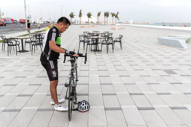 ABU DHABI, UNITED ARAB EMIRATES. 27 MAY 2018. Opening of Hudayriat beach next to Al Bateen beach.A man takes a break from cycling on the cycle track. (Photo: Antonie Robertson/The National) Journalist: Haneen Dajani. Section: National.