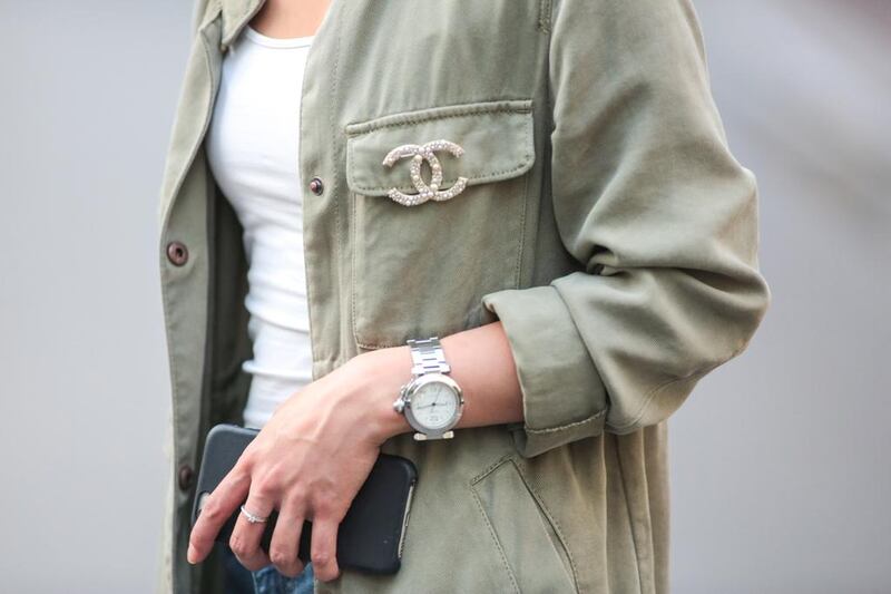 May Berthelot (Head of Legal at Videdressing.com - @maymaryb), is wearing a Chanel boy bag, a Chanel brooch, a Zara green jacket, an H&M white top. Edward Berthelot / Getty Images