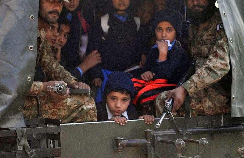 Pakistani soldiers transport rescued school children from the site of an attack by Taliban gunmen on a school in Peshawar. A Majeed / AFP Photo 