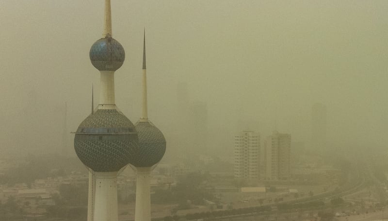 Buildings are shrouded in heavy dust in Kuwait City, Kuwait. The Kuwaiti Ministry of Interior on Sunday cautioned against a prevailing unsteady weather marked with a wave of dust that lowered visibility.   EPA 