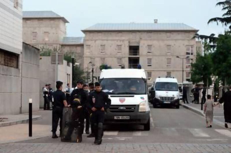 French riot police stand guard in front of the police station in Trappes, a suburb of Paris, after violence erupted after police carried an identity check on a woman wearing a niqab.