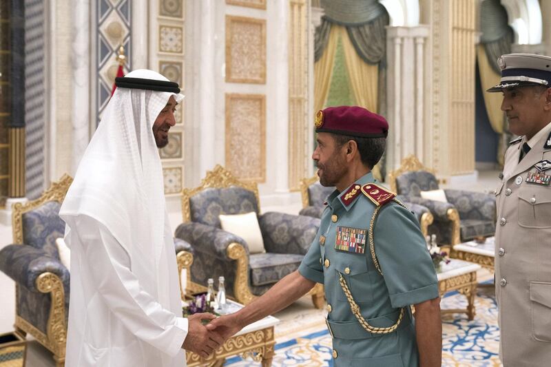 ABU DHABI, UNITED ARAB EMIRATES - May 20, 2018: HH Sheikh Mohamed bin Zayed Al Nahyan Crown Prince of Abu Dhabi Deputy Supreme Commander of the UAE Armed Forces (L), receives a member of the Abu Dhabi Police (C), during an iftar reception at the Presidential Palace. Seen with HE Major General Mohamed Khalfan Al Romaithi, Commander in Chief of Abu Dhabi Police and Head of Security, Justice, Health and Safety Committee of Abu Dhabi Executive Council (R).

( Hamad Al Kaabi / Crown Prince Court - Abu Dhabi )
---