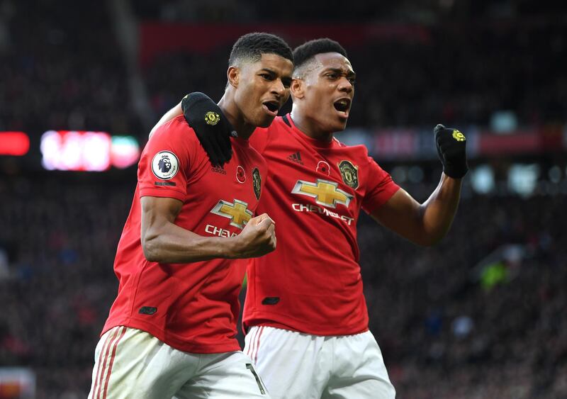 Marcus Rashford of Manchester United celebrates with teammate Anthony Martial after scoring his team's third goal against Brighton and Hove Albion at Old Trafford on Sunday. Getty Images