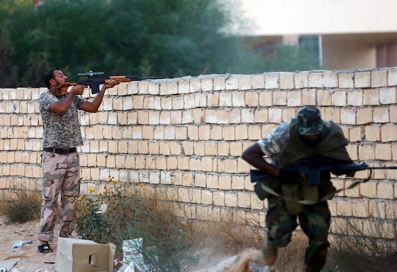 Members of Libya's Shield Brigade clash with gunmen accused of being loyal to the former Qaddafi regime. Mahmud Turkia / AFP