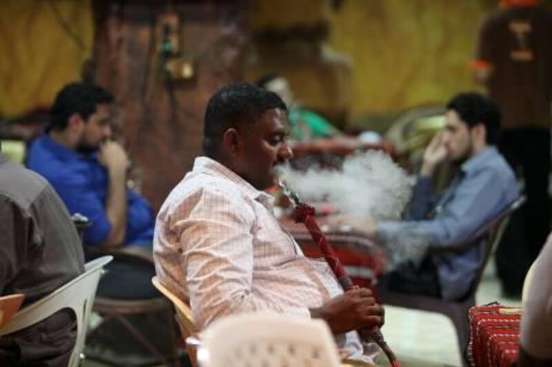 
AJMAN , UNITED ARAB EMIRATES Ð Dec 14 : People enjoying shisha at Al Sindibad coffee shop & cafeteria in nuaimiya area in Ajman. ( Pawan Singh / The National ) For News. Story by Yasin
