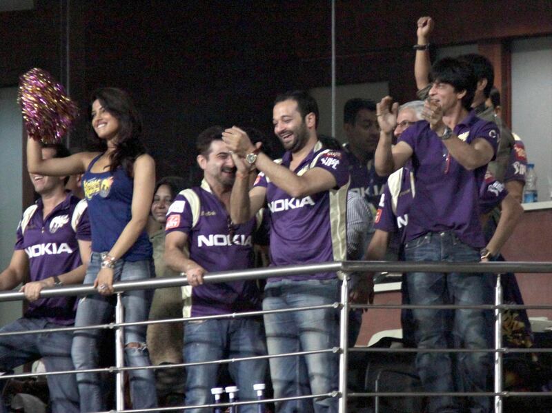 RESTRICTED TO EDITORIAL USE. MOBILE USE WITHIN NEWS PACKAGE

Indian Bollywood actor and co-owner of Kolkata Knight Riders Shah Rukh Khan (R) and  actress Priyanka Chopra (L) gesture during the IPL Twenty20 cricket match between Kolkata Knight Riders and Kings XI Punjab at The Eden Garden Stadium on April 30, 2011.  AFP PHOTO/STR (Photo by STRDEL / AFP)